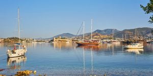 View of Bodrum Beach, Aegean sea, traditional white houses, flowers, marina, sailing boats, yachts in Bodrum town Turkey.